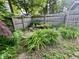 Zen backyard pond with greenery, rocks, and a classic wooden privacy fence at 5002 Broadway St, Indianapolis, IN 46205