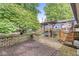 Picturesque backyard featuring a pergola swing, lush landscaping, and custom metal art at 5002 Broadway St, Indianapolis, IN 46205