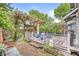 Charming backyard with wooden deck, brick patio, and a pergola with hanging bicycles at 5002 Broadway St, Indianapolis, IN 46205