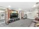 Finished basement with laundry, TV, and workout area featuring dark gray carpet and light paint colors at 5002 Broadway St, Indianapolis, IN 46205