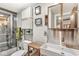 Well-lit bathroom with updated sink, vanity, shower with glass doors, and modern toilet at 5002 Broadway St, Indianapolis, IN 46205