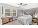 A bright bedroom featuring two large windows, a desk area, and hardwood floors at 5002 Broadway St, Indianapolis, IN 46205