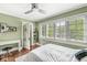 A light filled bedroom with hardwood floors, a desk, and lots of windows at 5002 Broadway St, Indianapolis, IN 46205