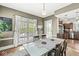 Dining room with a clear glass table, hardwood floors, and French doors leading to an outdoor space at 5002 Broadway St, Indianapolis, IN 46205