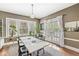 Elegant dining room with a modern table, bright windows, and access to the outdoor deck at 5002 Broadway St, Indianapolis, IN 46205