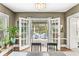 Dining room with French doors opening to a deck featuring outdoor seating, blending indoor-outdoor living at 5002 Broadway St, Indianapolis, IN 46205