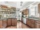 A spacious kitchen with dark wood cabinets, stainless steel appliances and an interesting spice rack display at 5002 Broadway St, Indianapolis, IN 46205