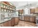 A spacious kitchen with dark wood cabinets, modern stainless appliances and skateboards holding spice jars at 5002 Broadway St, Indianapolis, IN 46205