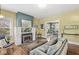 Bright living room featuring a fireplace, hardwood floors, and a view into the dining area at 5002 Broadway St, Indianapolis, IN 46205