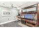 The office features a modern ceiling fan, artwork, built-in shelves, desk, computer, and stylish rolling chair at 5002 Broadway St, Indianapolis, IN 46205