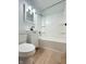 Bathroom featuring a vanity sink, mirror, toilet, shower and bathtub with bright white finish and flooring at 503 Elmhurst Pl, Whiteland, IN 46184
