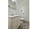 Bathroom featuring a single sink vanity with white cabinets, a toilet, and eye-catching patterned tile flooring at 503 Elmhurst Pl, Whiteland, IN 46184