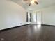 Bright bedroom featuring wood-look floors, white walls, a window with curtains, and a closet with sliding doors at 503 Elmhurst Pl, Whiteland, IN 46184