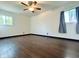 Bright bedroom featuring two windows, wood-look floors, neutral walls, and a ceiling fan at 503 Elmhurst Pl, Whiteland, IN 46184