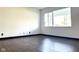 Bright and airy bedroom featuring neutral walls, wood-look floors, and a window allowing natural light at 503 Elmhurst Pl, Whiteland, IN 46184