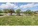 Scenic view of a backyard with lush green grass, trees, and a serene lake, ideal for outdoor enjoyment at 5038 Allisonville Rd # E, Indianapolis, IN 46205