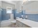 Bathroom features a tub with shower and blue tile throughout at 5038 Allisonville Rd # E, Indianapolis, IN 46205