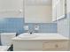 Bathroom featuring a tiled wall and vanity with sink at 5038 Allisonville Rd # E, Indianapolis, IN 46205