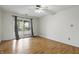 Bedroom featuring hardwood flooring, ceiling fan and balcony access at 5038 Allisonville Rd # E, Indianapolis, IN 46205