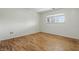Minimal bedroom with hardwood floors and a window for natural light at 5038 Allisonville Rd # E, Indianapolis, IN 46205