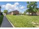 Traditional brick exterior with mature landscaping, a sprawling lawn, and natural light at 5038 Allisonville Rd # E, Indianapolis, IN 46205