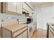 Functional kitchen with white cabinets and appliances at 5038 Allisonville Rd # E, Indianapolis, IN 46205