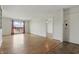 Bright living room featuring hardwood floors, built in shelving, and large windows with outdoor views at 5038 Allisonville Rd # E, Indianapolis, IN 46205