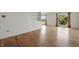 Bright living room featuring hardwood floors, built in shelving, and large windows with beautiful views at 5038 Allisonville Rd # E, Indianapolis, IN 46205
