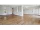 Spacious living room with hardwood floors, built-in shelving, and access to a bright, airy sunroom at 5038 Allisonville Rd # E, Indianapolis, IN 46205