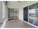 The sunroom features sliding doors, tile floors, and access to the backyard at 5038 Allisonville Rd # E, Indianapolis, IN 46205