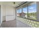 The sunroom features tile floors, large glass windows, and a ceiling fan at 5038 Allisonville Rd # E, Indianapolis, IN 46205
