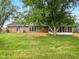 Spacious backyard featuring mature trees and a well-maintained lawn at 5200 N Leslie Dr, Muncie, IN 47304