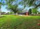 View of the backyard with enclosed patio and mature tree at 5200 N Leslie Dr, Muncie, IN 47304