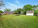 Expansive backyard with a large lawn, mature trees, and an outbuilding at 5200 N Leslie Dr, Muncie, IN 47304