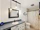 Neutral bathroom features a dark vanity and framed mirror, with tub and shower combo at 5200 N Leslie Dr, Muncie, IN 47304