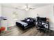 Bedroom featuring wood-look flooring, a ceiling fan, window and black furniture at 5200 N Leslie Dr, Muncie, IN 47304