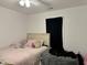 Comfortable bedroom with soft lighting, featuring a cozy bed with stylish pillows and a modern beanbag chair at 5200 N Leslie Dr, Muncie, IN 47304