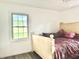 Bright bedroom with a window, a wooden bed frame, and neutral decor, offering a relaxing and comfortable space at 5200 N Leslie Dr, Muncie, IN 47304