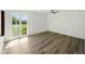 Bright bedroom with modern ceiling fan, large window with green backyard view and light-colored floors at 5200 N Leslie Dr, Muncie, IN 47304