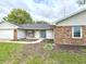 Charming single-story home featuring a welcoming entrance, well-maintained lawn, and a blend of brick and siding exterior at 5200 N Leslie Dr, Muncie, IN 47304