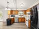 Charming eat-in kitchen with wood cabinets, stainless appliances, and light countertops at 5200 N Leslie Dr, Muncie, IN 47304