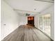 Bright living room features light wood flooring, a brick fireplace, and sliding glass doors to porch at 5200 N Leslie Dr, Muncie, IN 47304