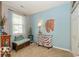 Cozy bedroom with ample natural light, neutral carpet, and stylish zebra accent at 5410 Brassie Dr, Indianapolis, IN 46235