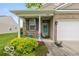Inviting front porch with decorative plants, seating, and charming details, perfect for relaxing outdoors at 5410 Brassie Dr, Indianapolis, IN 46235