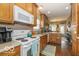 Efficient kitchen featuring wood cabinetry, modern appliances, and laminate countertops at 5410 Brassie Dr, Indianapolis, IN 46235
