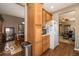Functional kitchen with warm wood cabinetry, laminate floors, and an eat-in dining area at 5410 Brassie Dr, Indianapolis, IN 46235