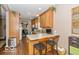 Efficient kitchen featuring wood cabinets and a breakfast bar with seating at 5410 Brassie Dr, Indianapolis, IN 46235
