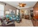 Comfortable living room with stylish furniture, ceiling fan, and an open view into the kitchen at 5410 Brassie Dr, Indianapolis, IN 46235