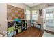 Well-organized mud room with storage solutions, a bench, and natural light from the backyard door at 5410 Brassie Dr, Indianapolis, IN 46235