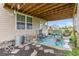 View of a covered patio featuring outdoor seating, a colorful rug and flower pots at 5410 Brassie Dr, Indianapolis, IN 46235